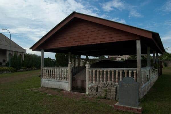 The inscribed boulder is under a shed in the far end of the church