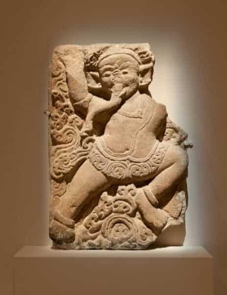 This wall relief is described as a dancer wearing an elephant mask. Does anyone know why this is identified as a dancer and not Ganesha?