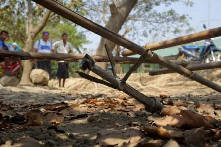 People look at an unexploded rocket in Mrauk U township in Rakhine State on March 16. Source: Frontier Myanmar 20190320